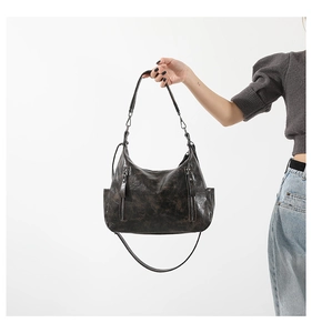 Detailed view of retro faux leather hobo bag with front zip pockets and side compartments