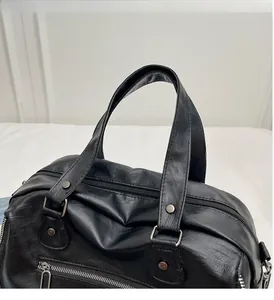Close-up of black retro tote bag handles with metal rivets and premium zipper detail