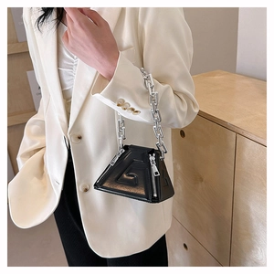 Detail of black triangular PU leather handbag with embossed G logo and chunky silver chain
