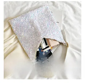 Detail view of the spacious interior of a white sequin tote bag showing storage capacity