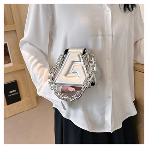 Close-up of silver geometric triangle handbag with chunky chain and embossed G detail