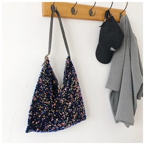Detail of colorful sequin hobo bag with a dark gray crocodile pattern leather strap