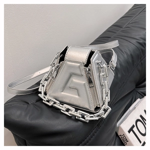 Silver metallic geometric handbag with embossed G design on a premium black leather backdrop
