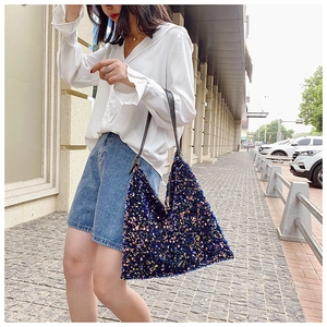 Detail of glittery sequin tote bag with colorful shimmer on a stylish shoulder bag