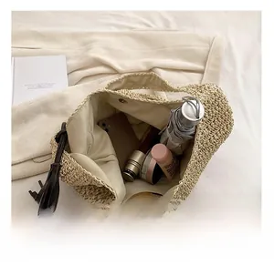 Large capacity straw tote bag interior showing phone, umbrella, and makeup storage