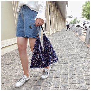 Detail of bohemian triangle tote bag with sparkling dark blue and multi-color sequins