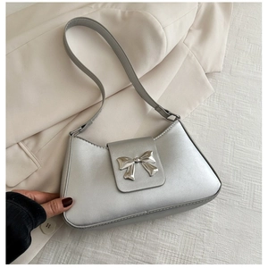 Silver metallic PU leather baguette handbag with a decorative metal bow accent