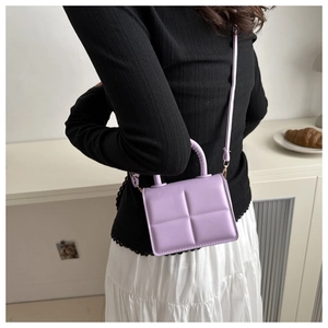 Close-up of small lavender PU leather crossbody bag with geometric square pattern