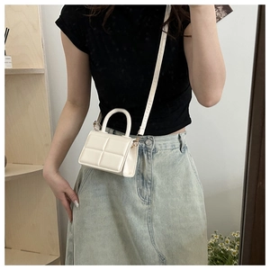 Mini white PU leather crossbody bag with square embossed pattern and adjustable strap