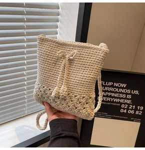 Detailansicht der cremefarbenen Häkel-Schultertasche mit Lochmuster und Kordelzug-Verschluss