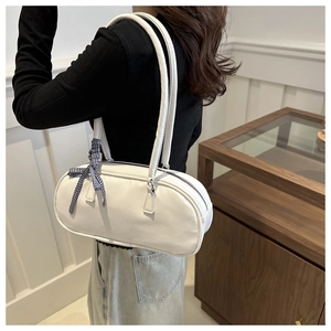 Side view of white cylindrical Boston bag with blue checkered ribbon detail and dual straps