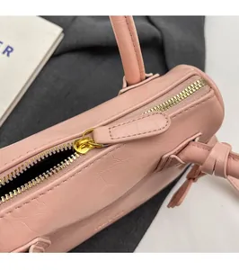 Detail of smooth gold metal zipper and premium light pink faux leather texture