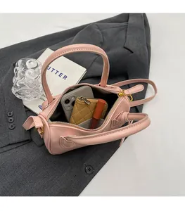 Internal view of pink faux leather bag showing space for phone, wallet and lipstick