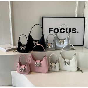 Bow accent handbags in black, silver, pink, and white with dual size chain straps