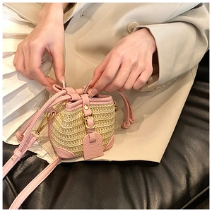 Mini straw bucket bag detail with pink lychee leather trim and adjustable drawstring