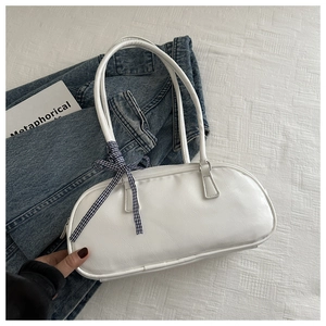 White pleated PU baguette bag with checkered bow ribbon on blue denim jacket