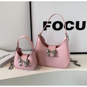 Detail of pink crescent bags with silver bow buckle in standard and mini sizes