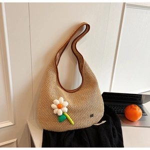 Handmade woven straw shoulder bag with large white daisy flower and leather trim details