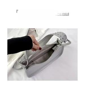 Macro view of interior layout with zippered pocket and silver studs on wide strap