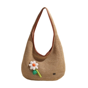 Handmade woven tote bag with a white knit flower and large capacity for beach trips
