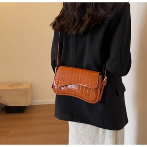 Polished faux crocodile leather underarm bag in caramel brown with curved base
