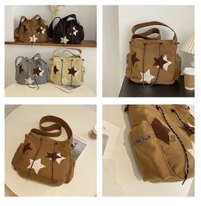 Detail of canvas messenger bag with star patches, drawstring design and side pockets