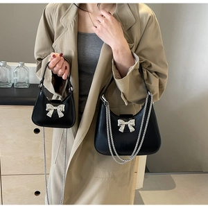 Comparison of black bow handbag in standard and mini sizes with silver chain straps