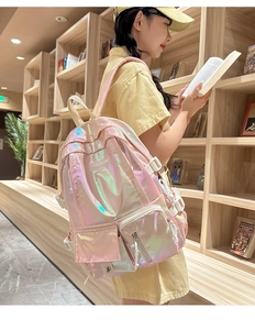 Detail of pink holographic backpack with multiple pockets in a bookstore library setting