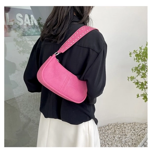 Pink faux leather shoulder bag with silver rivet details on strap and vertical seams
