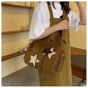 Brown canvas messenger bag with star patches and drawstring for students
