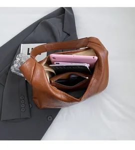 Close-up of spacious interior in brown leather tote bag with storage for tablet and books
