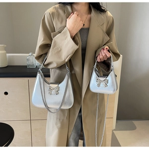 Silver bow accent crescent bags in large and mini sizes with metallic chain straps
