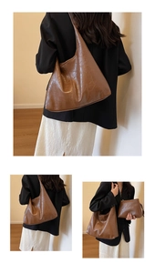 Detail view of dark brown retro tote bag set with natural leather texture and small pouch