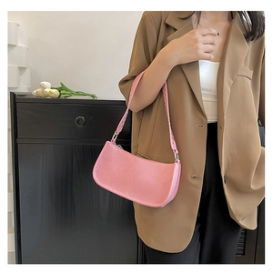 Pink shoulder bag detail showing silver rivets on the strap and decorative vertical stitching