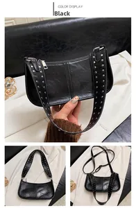 Detail view of black glossy shoulder bag featuring silver rivets on adjustable strap