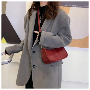 Chic burgundy faux leather crossbody bag styled with a gray oversized blazer