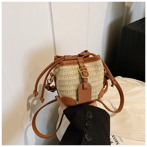 Fashionable straw bucket bag with dark brown leather trim and drawstring for women