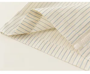 Detail of blue and white striped fabric with a hidden zipper closure on the hemline