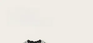 Close-up of gray neckline with black ruffle trim on girls' polka dot cotton outfit