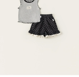 Detail of gray ribbed tank top with black trim and polka dot shorts with white lace