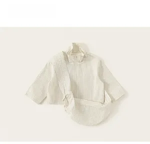 Detailed flat lay of striped girls' zipper jacket and matching crossbody bag set