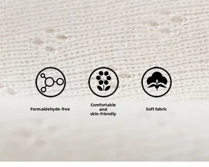 Close-up of soft white knitted cotton fabric with hollow pattern for kids' clothing
