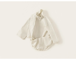 Detail of baby striped cotton set featuring zipper jacket and romper in light blue and beige