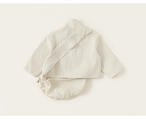 Flat lay of striped cotton baby set with long sleeve top and matching pumpkin shorts