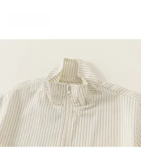 Close-up of kids striped shirt neckline with stand collar and white resin zipper detail