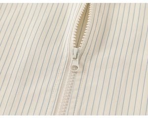 Macro detail of high-quality striped cotton fabric and durable white resin zipper closure