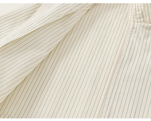 Detail of blue and white striped children shirt with high-quality zipper and cotton texture
