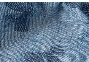 Detailed macro view of the soft blue bow pattern fabric and fine woven texture
