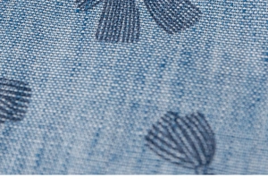 Macro shot of light blue floral jacquard fabric with delicate textured weave and patterns