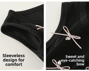 Detail of girls sleeveless dress with pink leather bows and silver heart charms